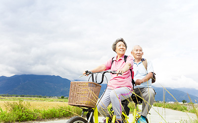 Senior couple riding a tandem-bike