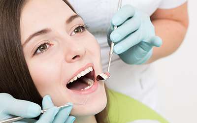 A patient having her teeth looked at