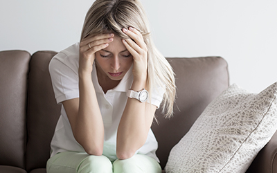 Woman putting her head into her hands depressed