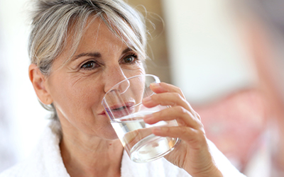 A woman drinking a glass of water