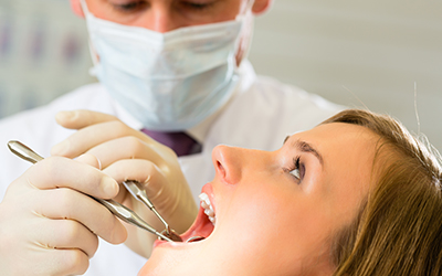 A woman having her teeth worked on by the dentist