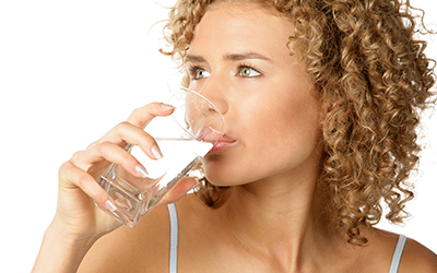 A woman drinking a glass of water