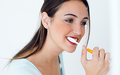 Young woman brushing her teeth