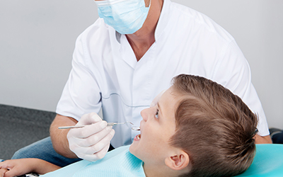 Child in chair with dentist